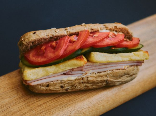 Ham and cheese sandwich on a wooden board