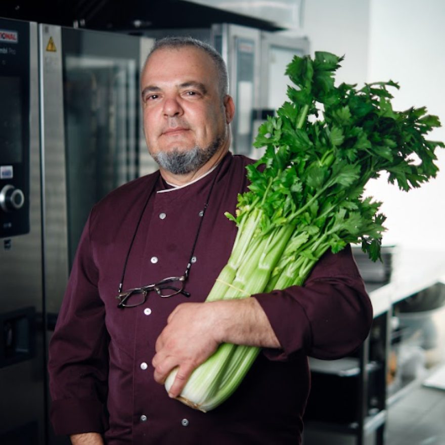 Chef holding a bunch of celery